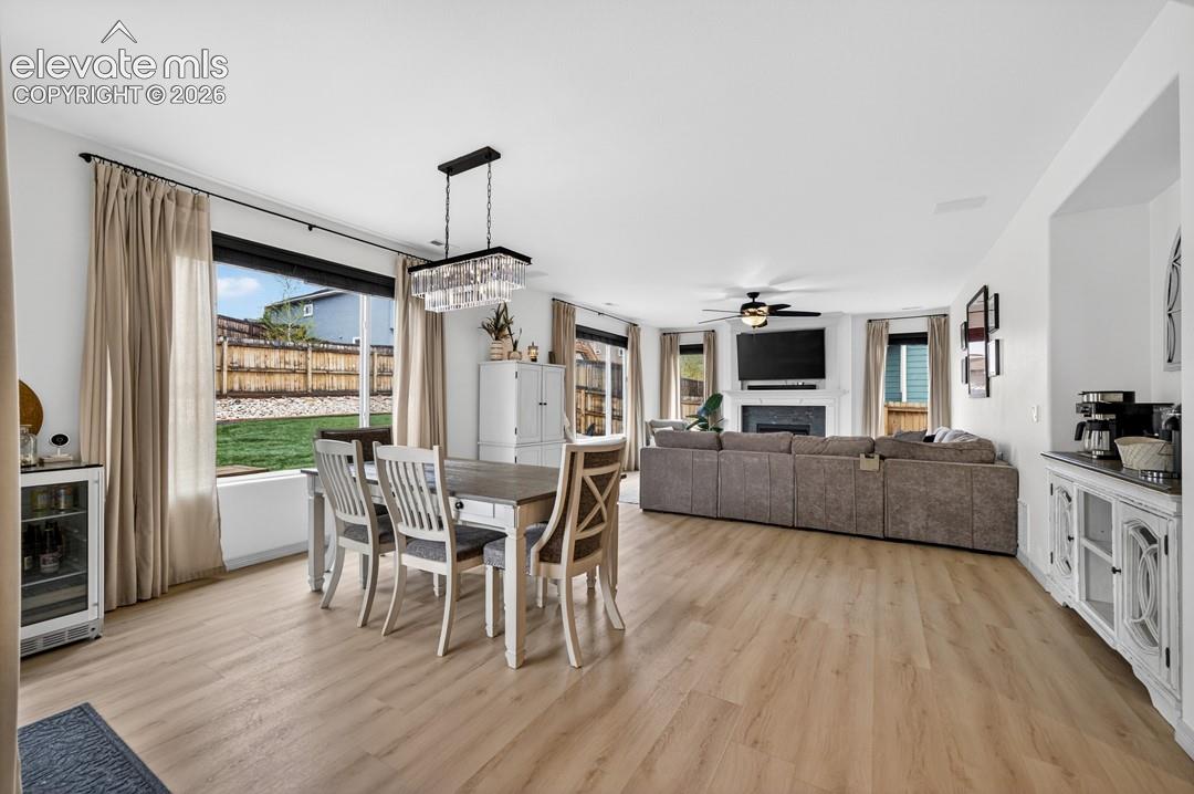 Walk out to backyard, luxury vinyl, chandelier, large windows