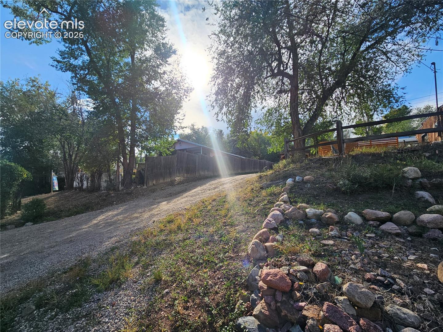 Gravel driveway and stone hillside tiers