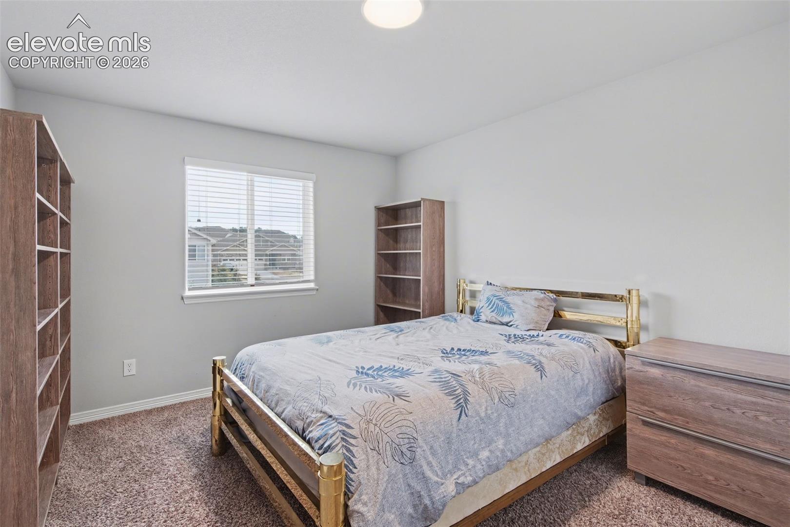 Window with horizontal blinds, neutral wall paint, and recessed ceiling lighting