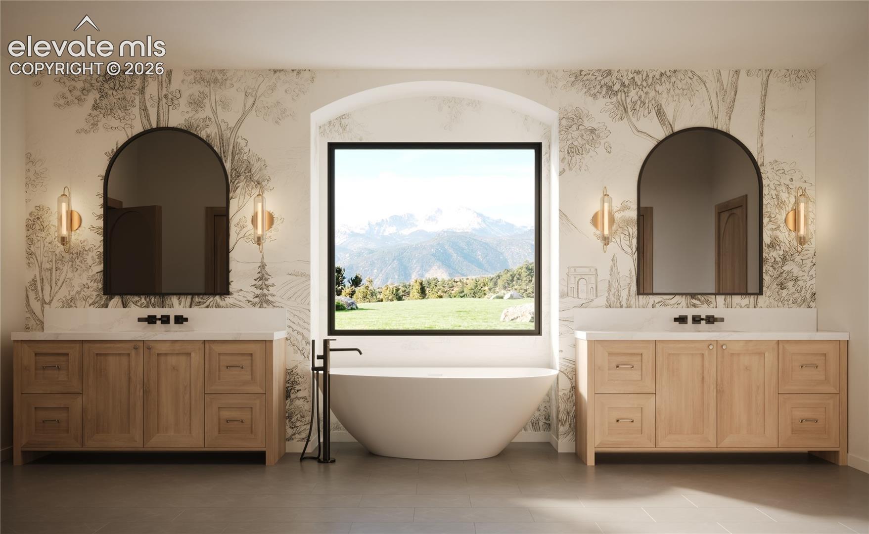Dual wood-finish vanities with countertop sinks, a freestanding soaking tub, and a large arched window