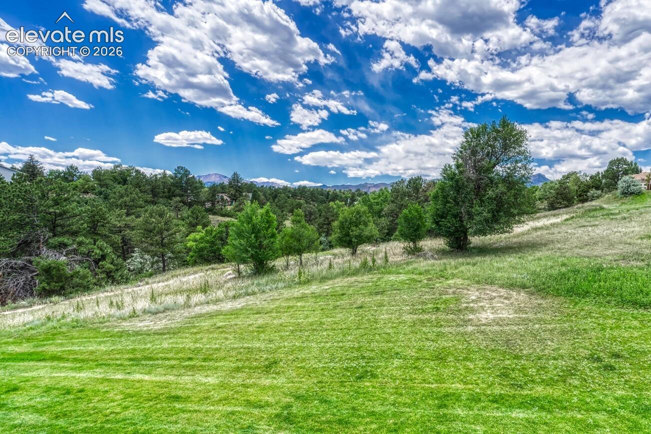 Primary bedroom overlooks open space and the front range