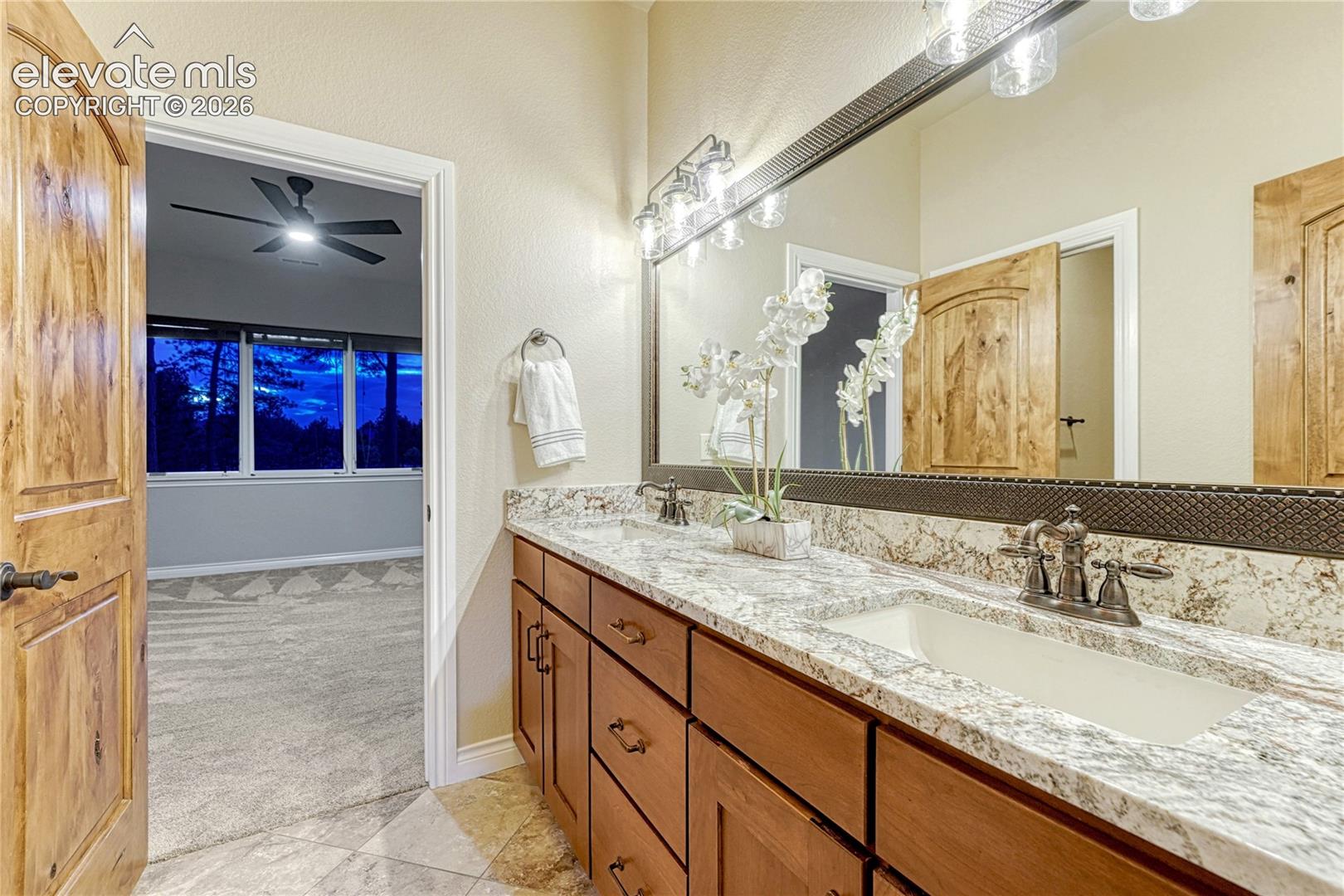Adjoining bathroom on the lower level, featuring new counters and lighting