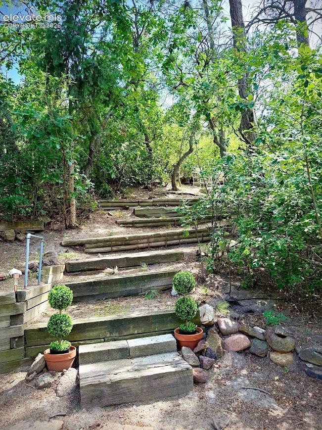 walk-way to sitting area on small hill in back yard