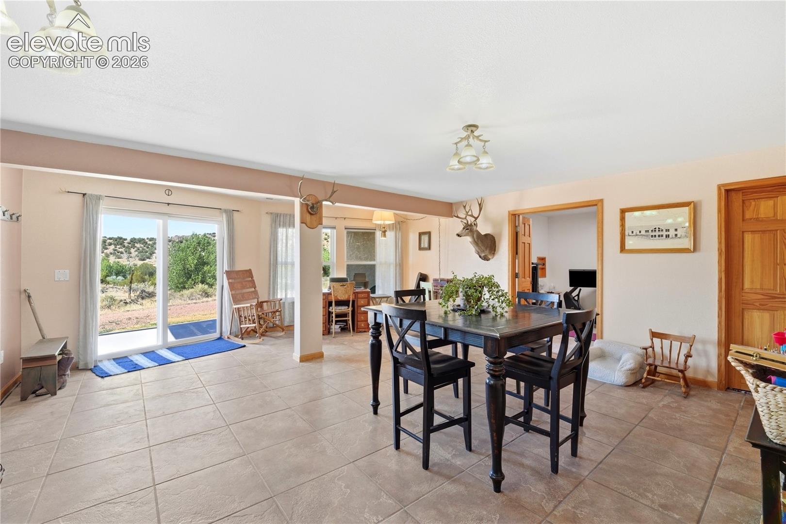 Tile flooring, recessed lighting, sliding glass door, and a built-in wood door