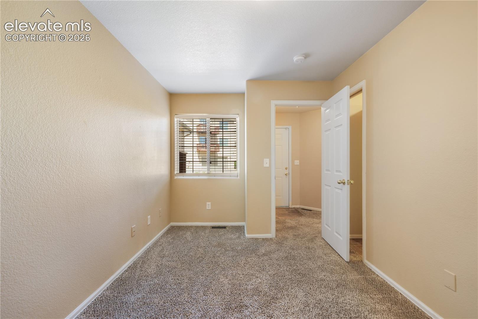 First bedroom, main floor at front of home with connecting access to the 3/4 bathroom