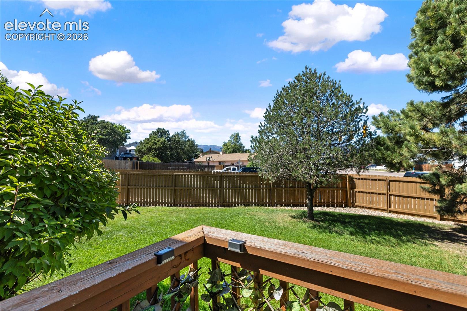 Looking off back deck large grass area, and mtn views. 