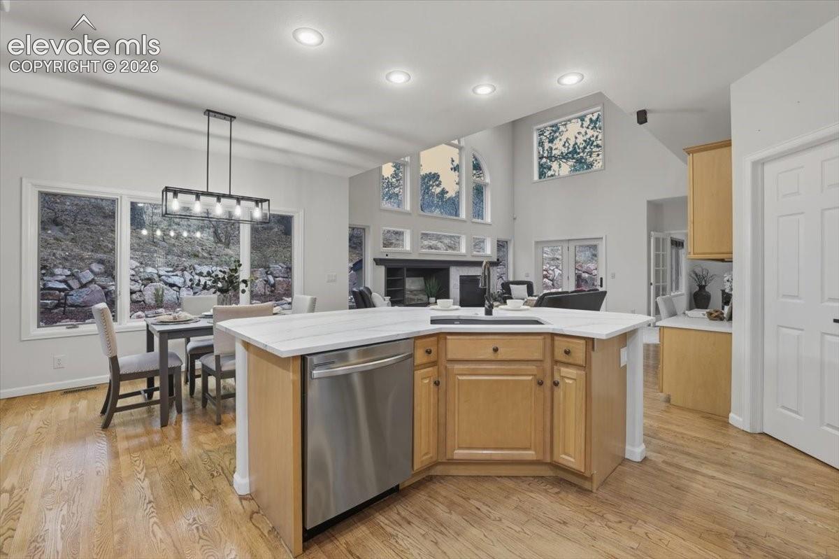 Kitchen island with integrated sink and stainless steel dishwasher