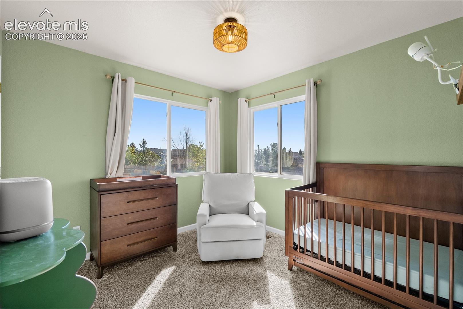 Room featuring two windows, recessed lighting, and soft green walls