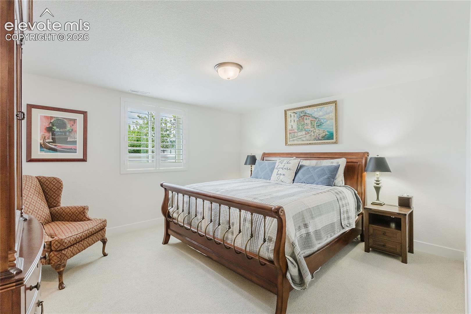 Bedroom in the lower level with plantation shutters and a walk in closet