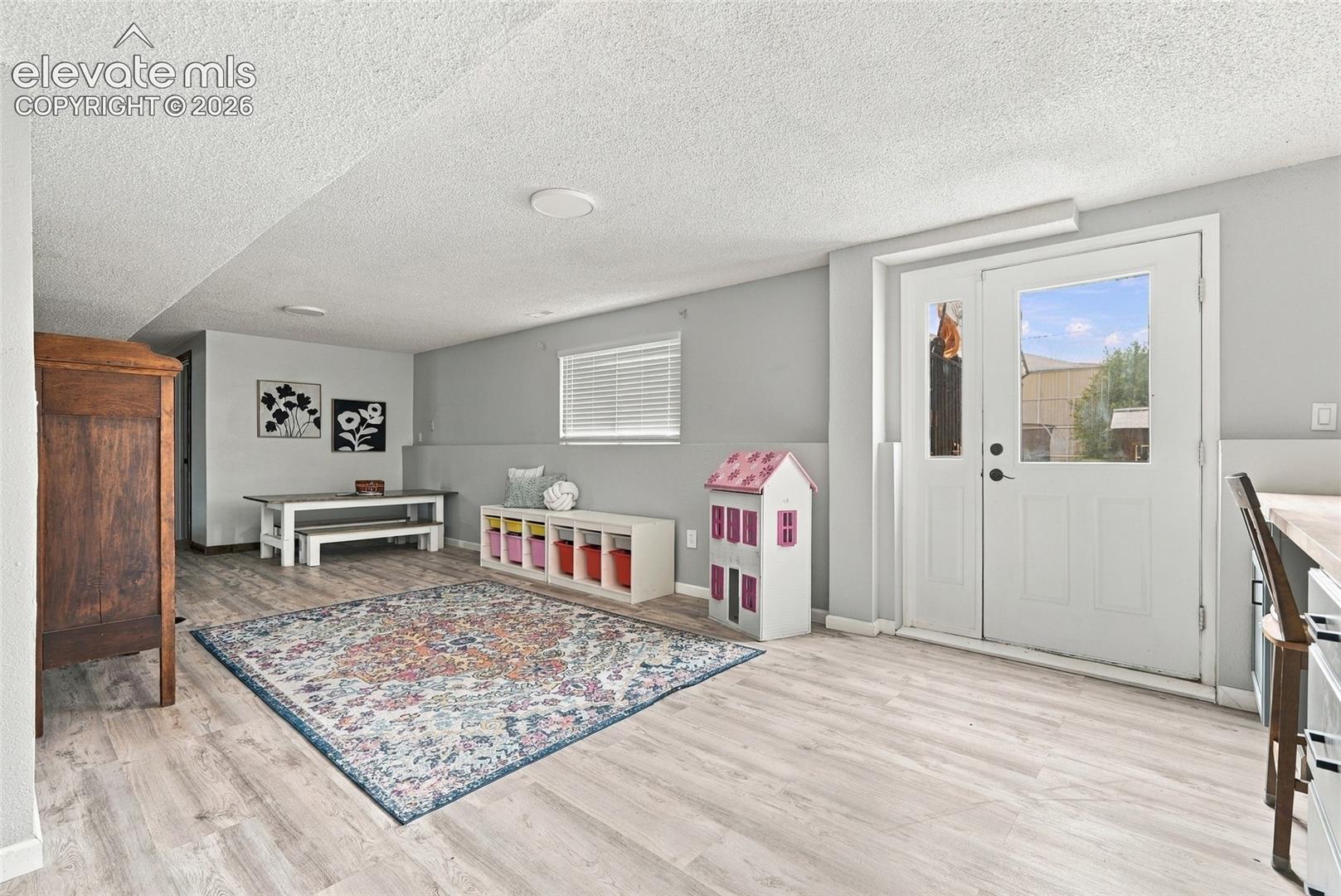 Light wood-finish flooring, recessed lighting, and a window with blinds