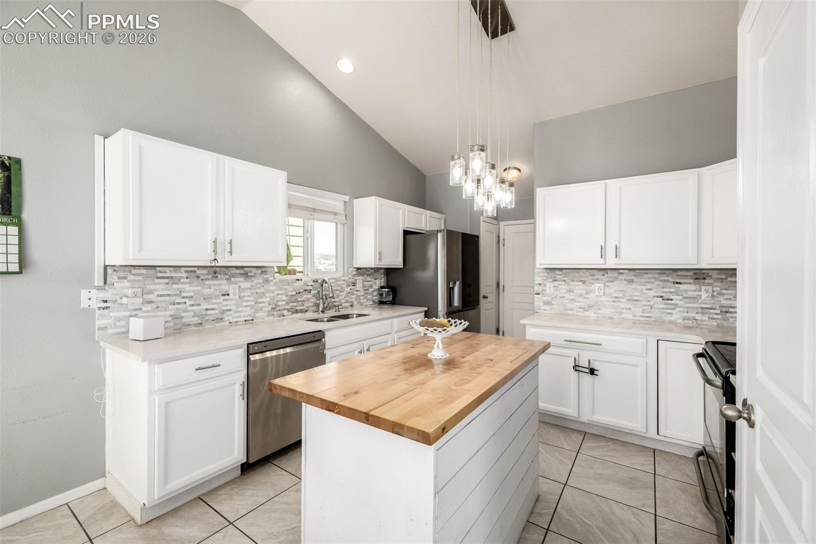 Updated Kitchen with beautiful white cabinetry and quartz/butcher block countertops
