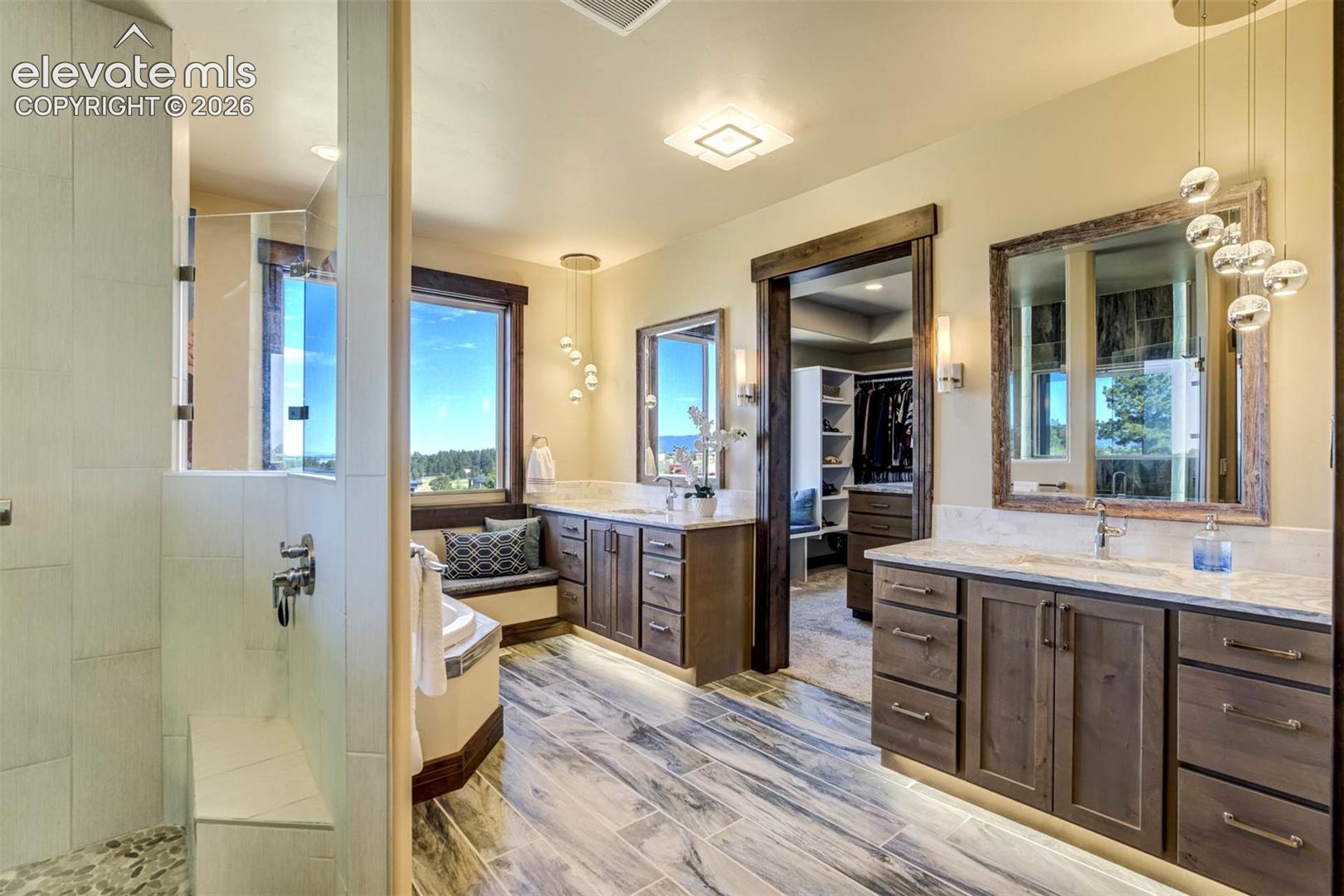 Master Bath features dual vanities, luxurious shower, soaking tub, separate water closet, and heated floors
