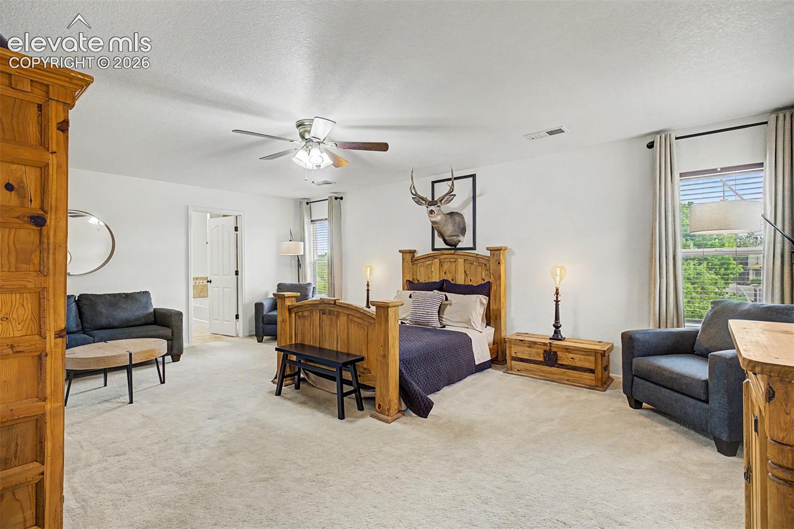 The primary suite offers an impressive footprint with space for a full sitting area, generous storage, and a bedroom experience that truly feels like a private retreat within the home.