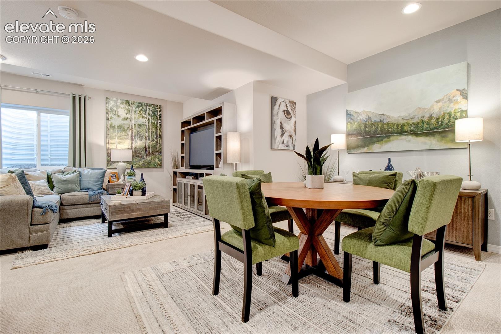 Open-concept interior featuring recessed lighting, a built-in media cabinet with shelving, and neutral wall-to-wall carpeting