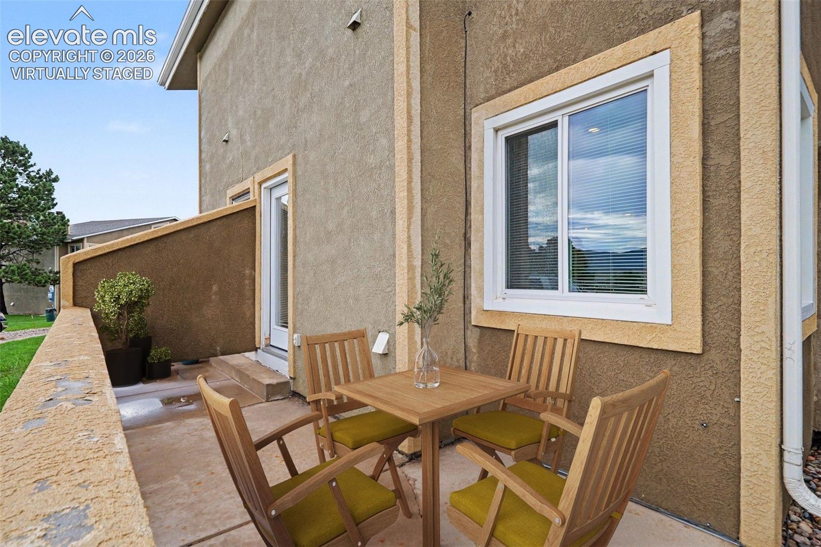 Virtually staged walk-out patio from living room, with mountain views