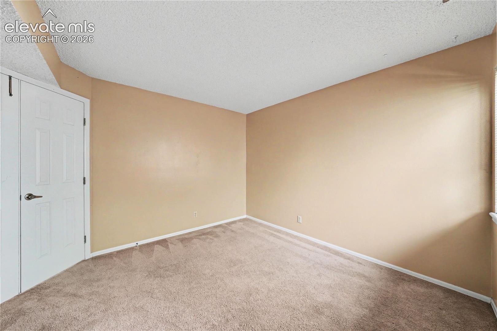 Bedroom with carpeted floors and neutral finishes