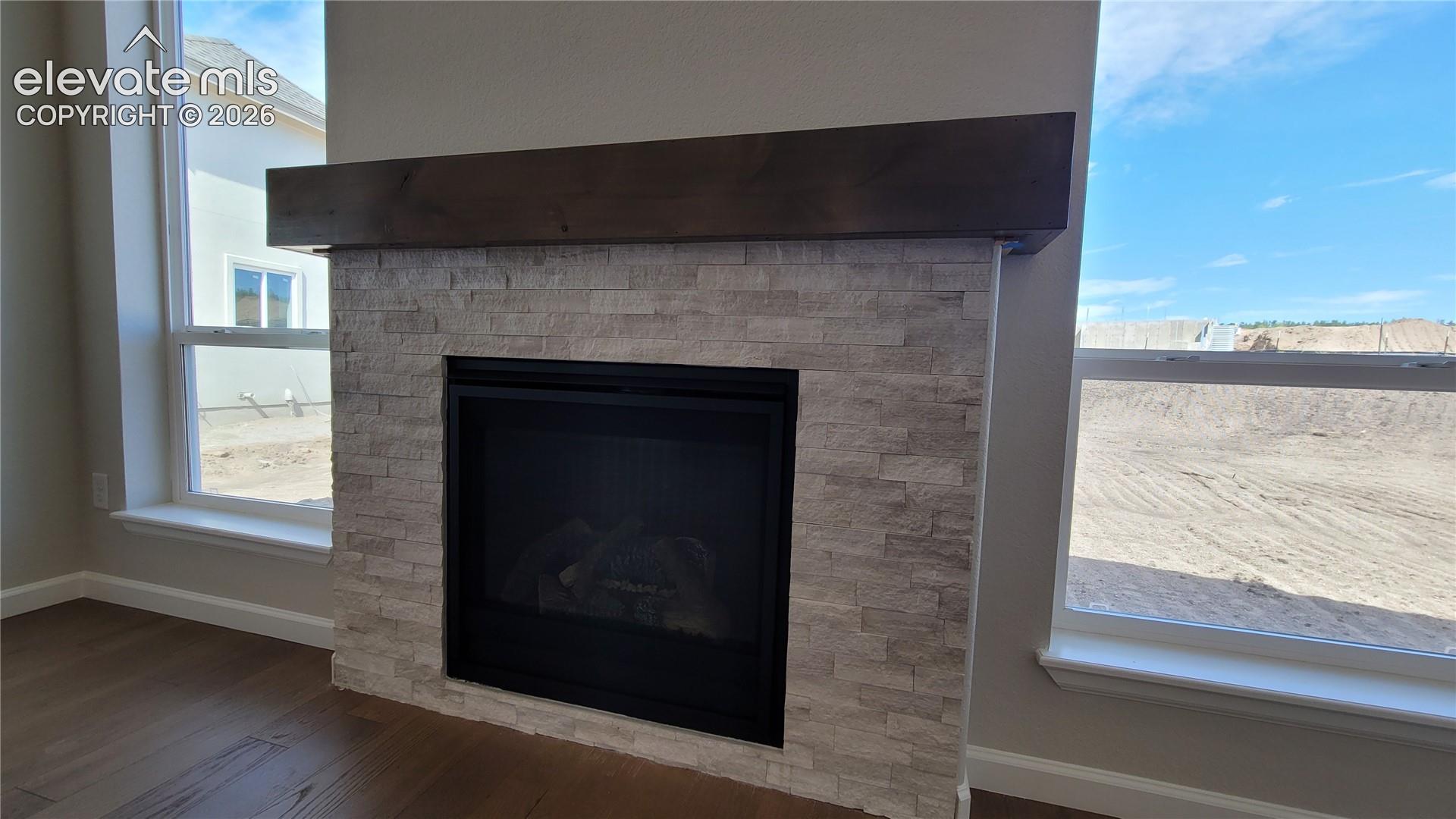 Gas Fireplace with stacked stone surround and a wood mantel! 