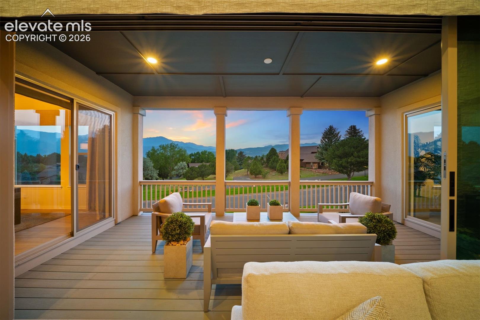 Expansive covered deck with recessed lighting, composite decking, with baluster railing.