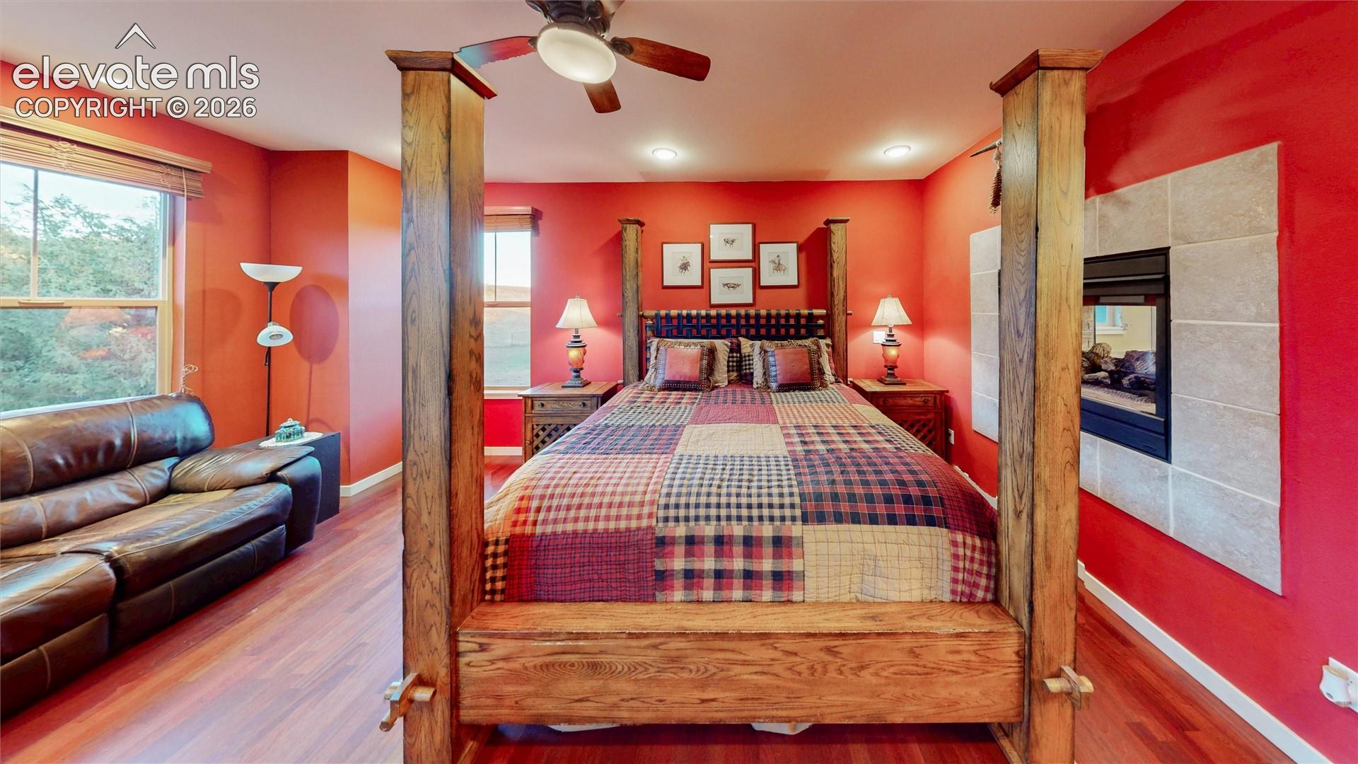 Main floor primary bedroom with 3-sided fireplace.