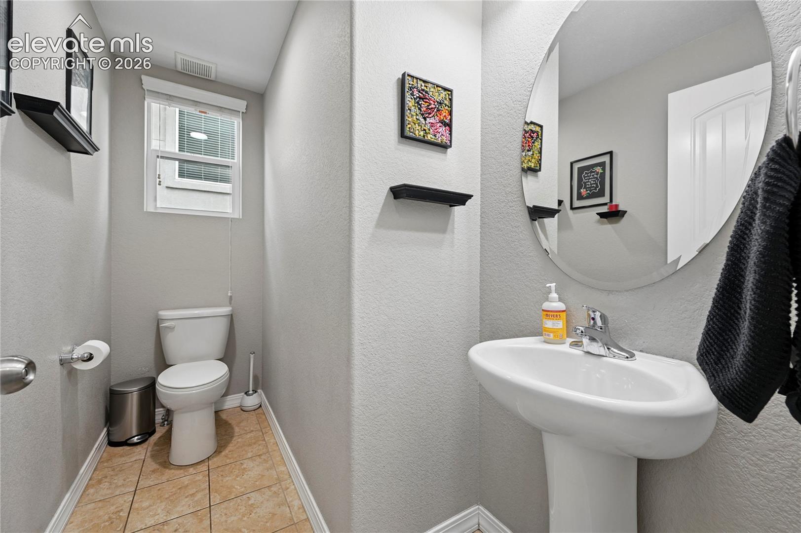 The main floor half bathroom is tucked just around the corner from the main living areas--convenient, but appropriately separated.