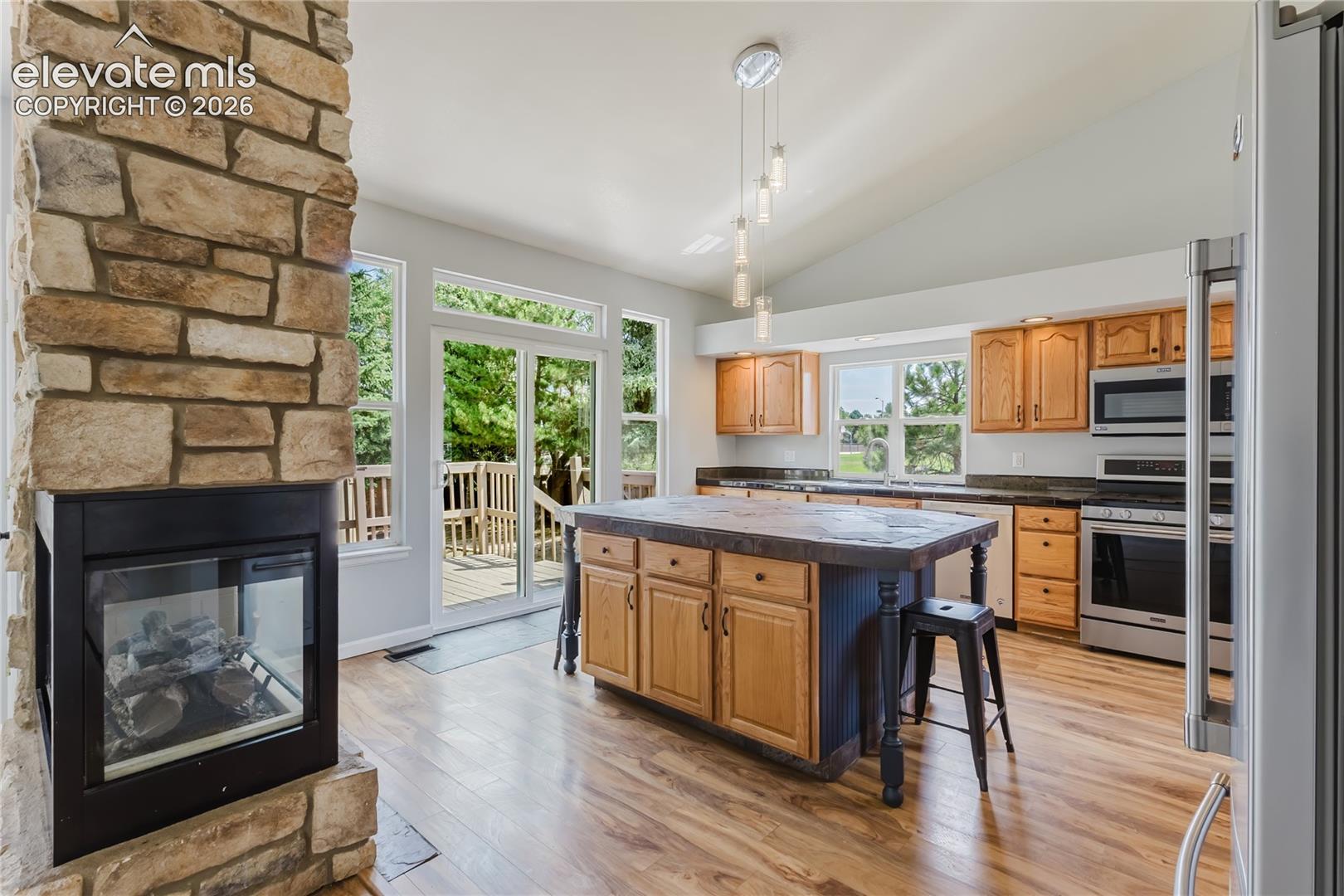 Stone-clad fireplace with glass doors