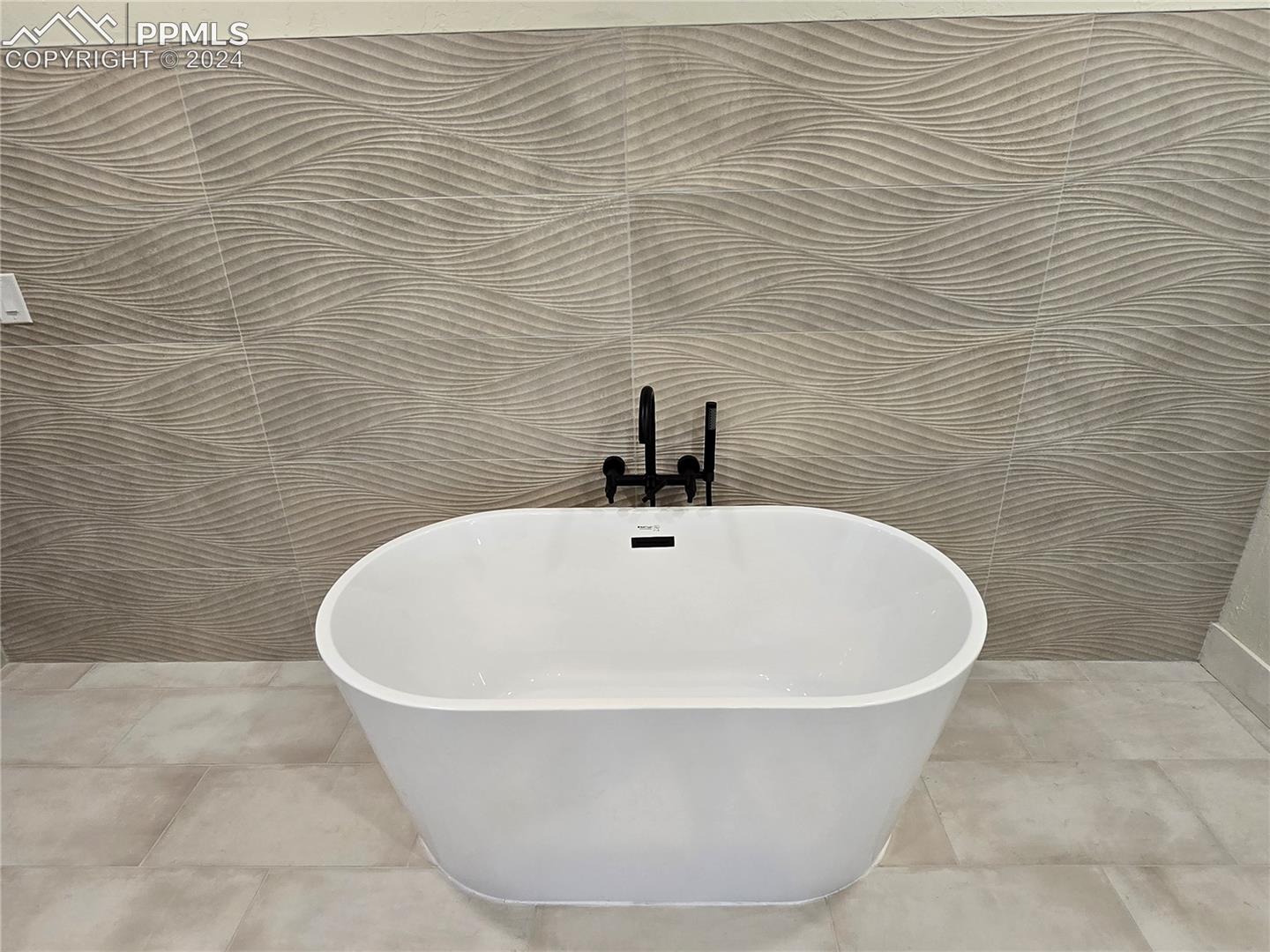 Details featuring a bathing tub and tile patterned floors