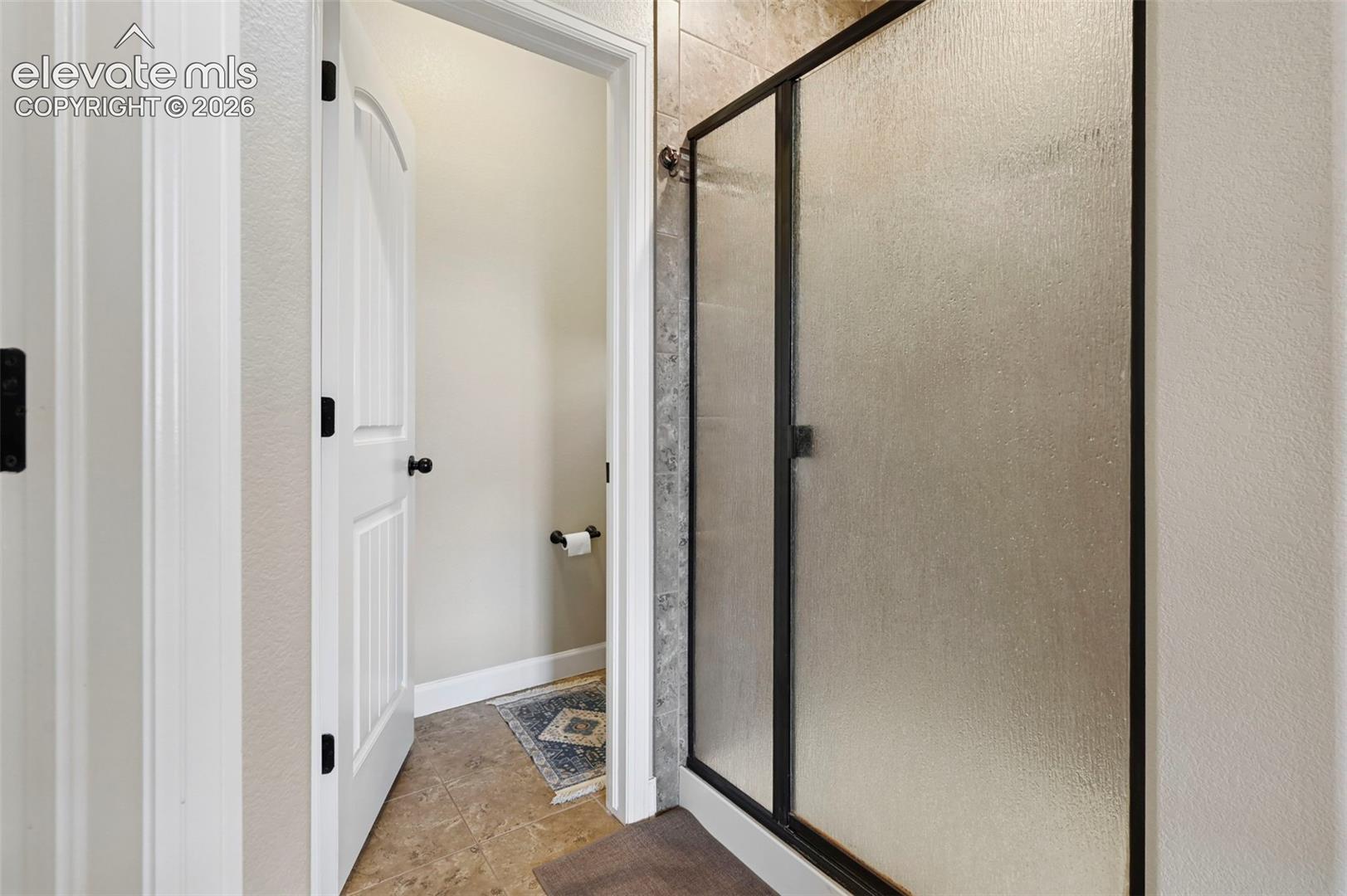 Frosted glass shower enclosure with dark framing