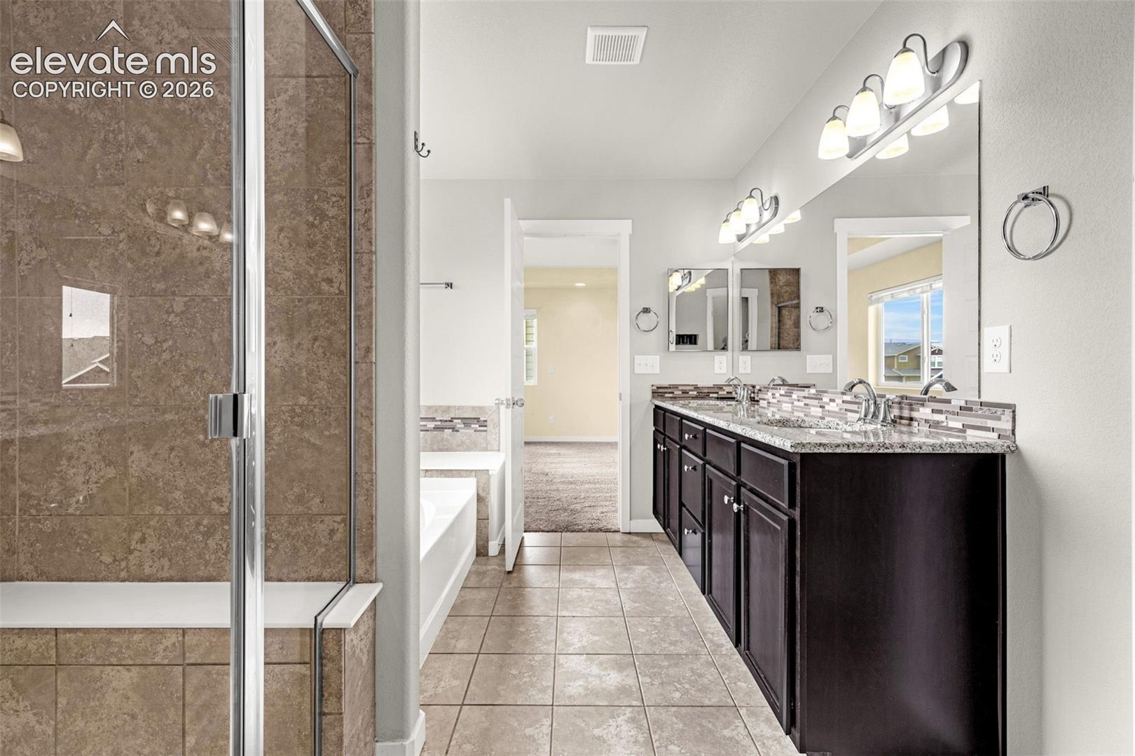 Dual vanity with dark wood-finish cabinetry and light-colored countertops