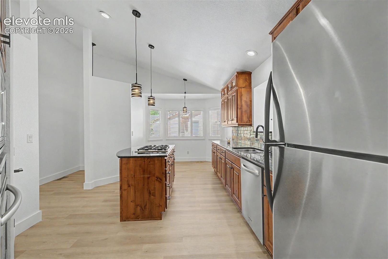 Kitchen with large center island and gas range 