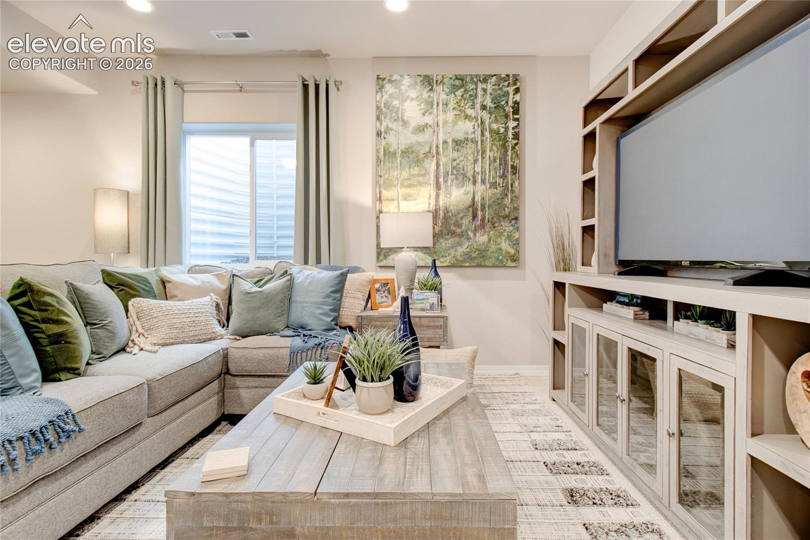 Built-in shelving unit featuring glass-front cabinets and open display shelving