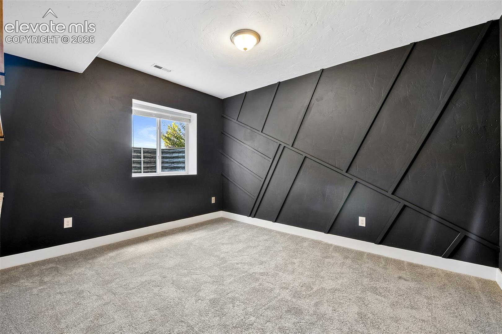 4th lower level bedroom with new carpet and walk-in closet