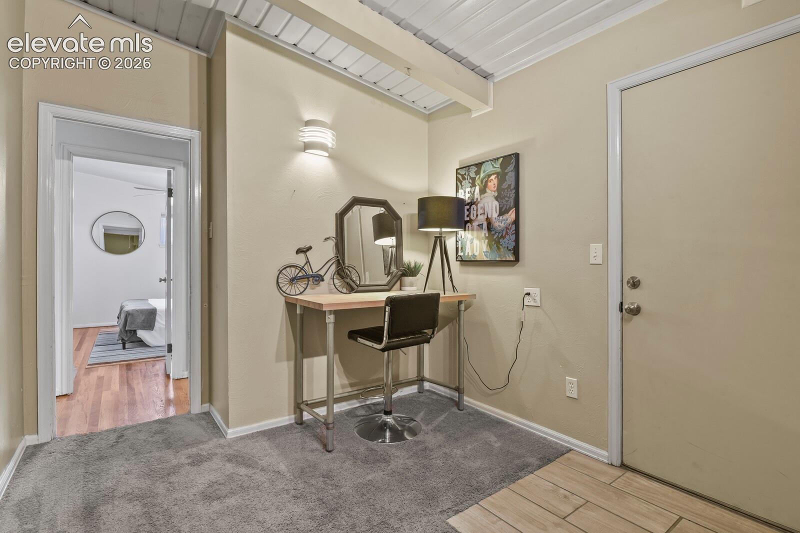 Small office area looking toward hallway and second, main-floor bedroom.
