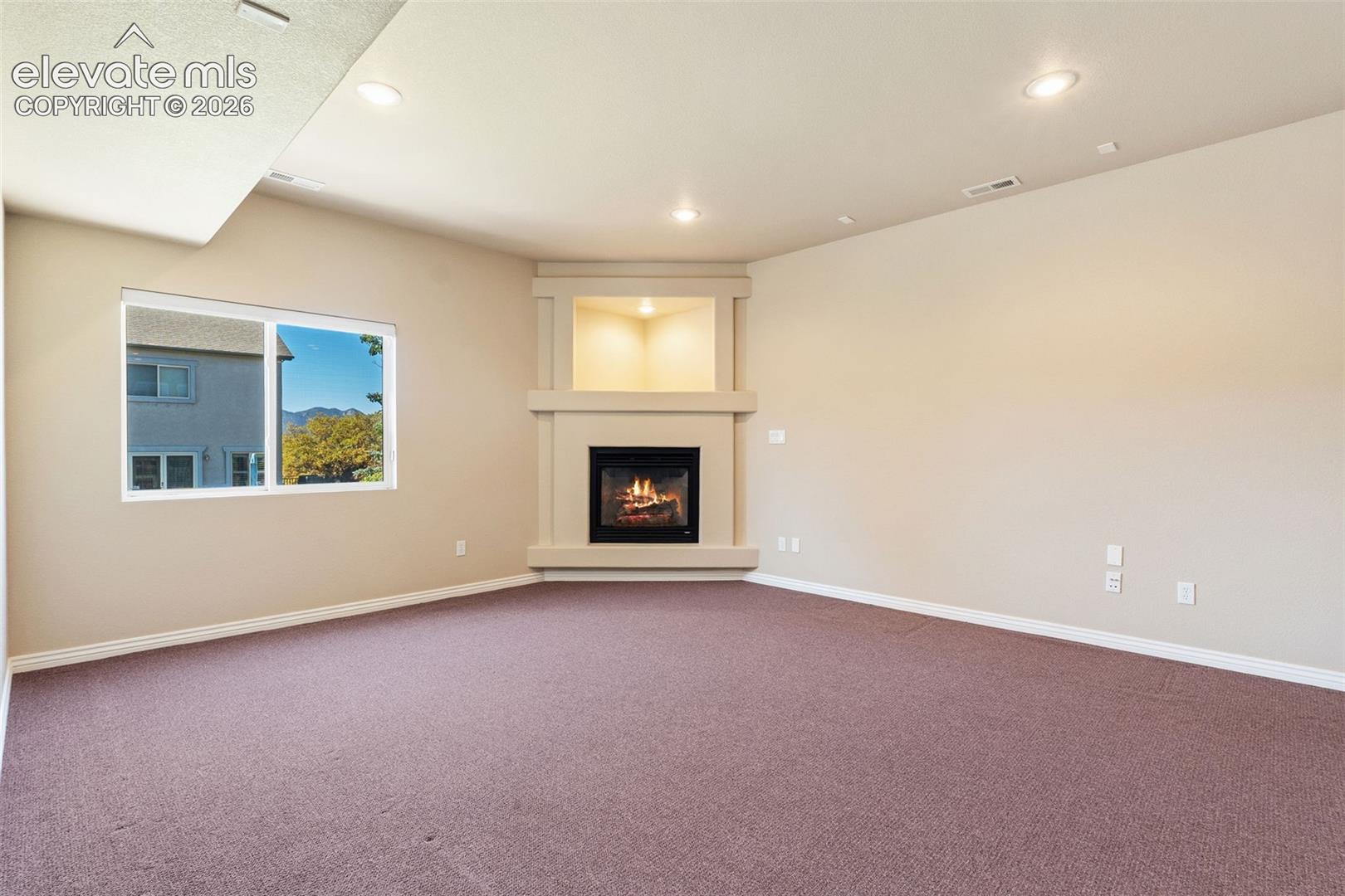 CORNER FIREPLACE WITH BUILT-IN SHELF & RECESSED LIGHTING