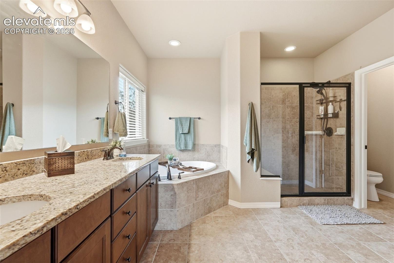 Primary ensuite with 5-piece bath. Granite countertops in all bathrooms, large shower and large soaking tub
