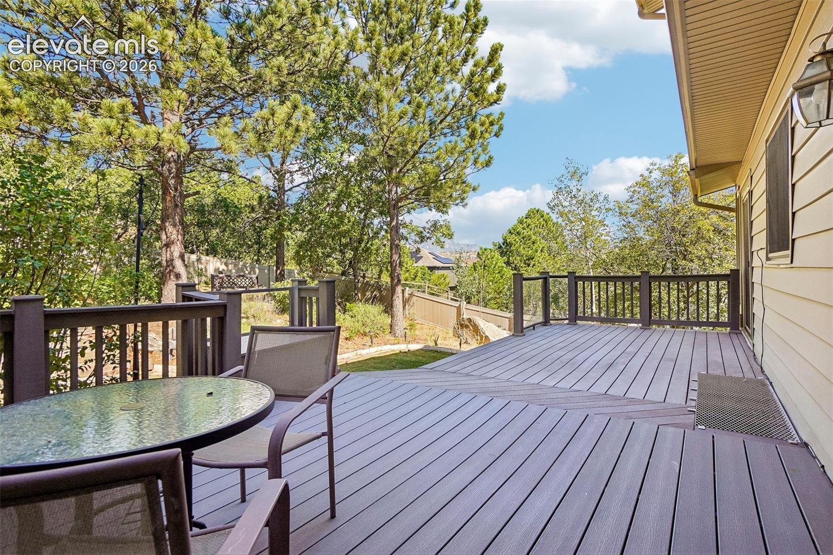 Large back deck with views of the mountains beyond.