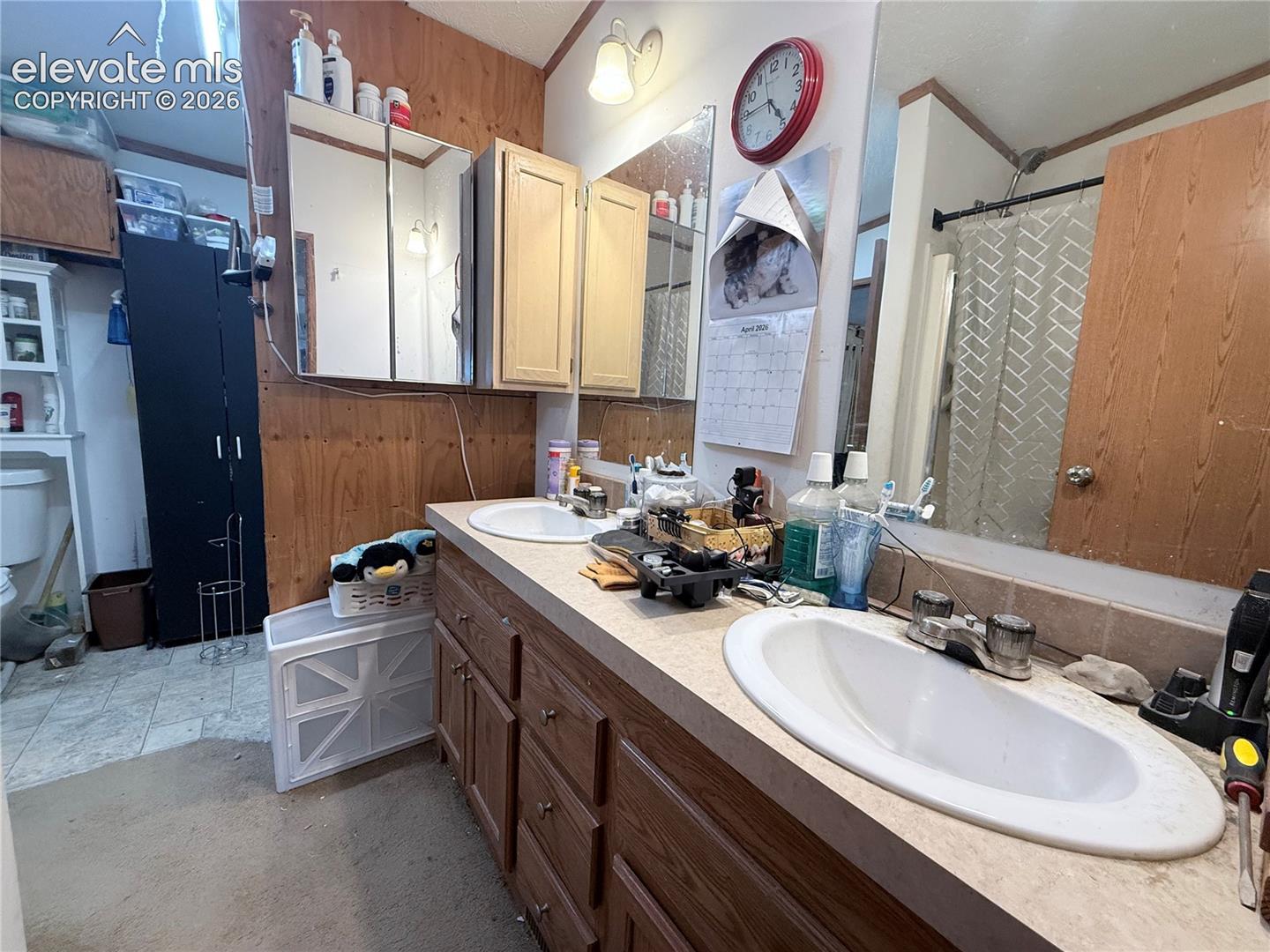 Bathroom with double vanity and curtained shower