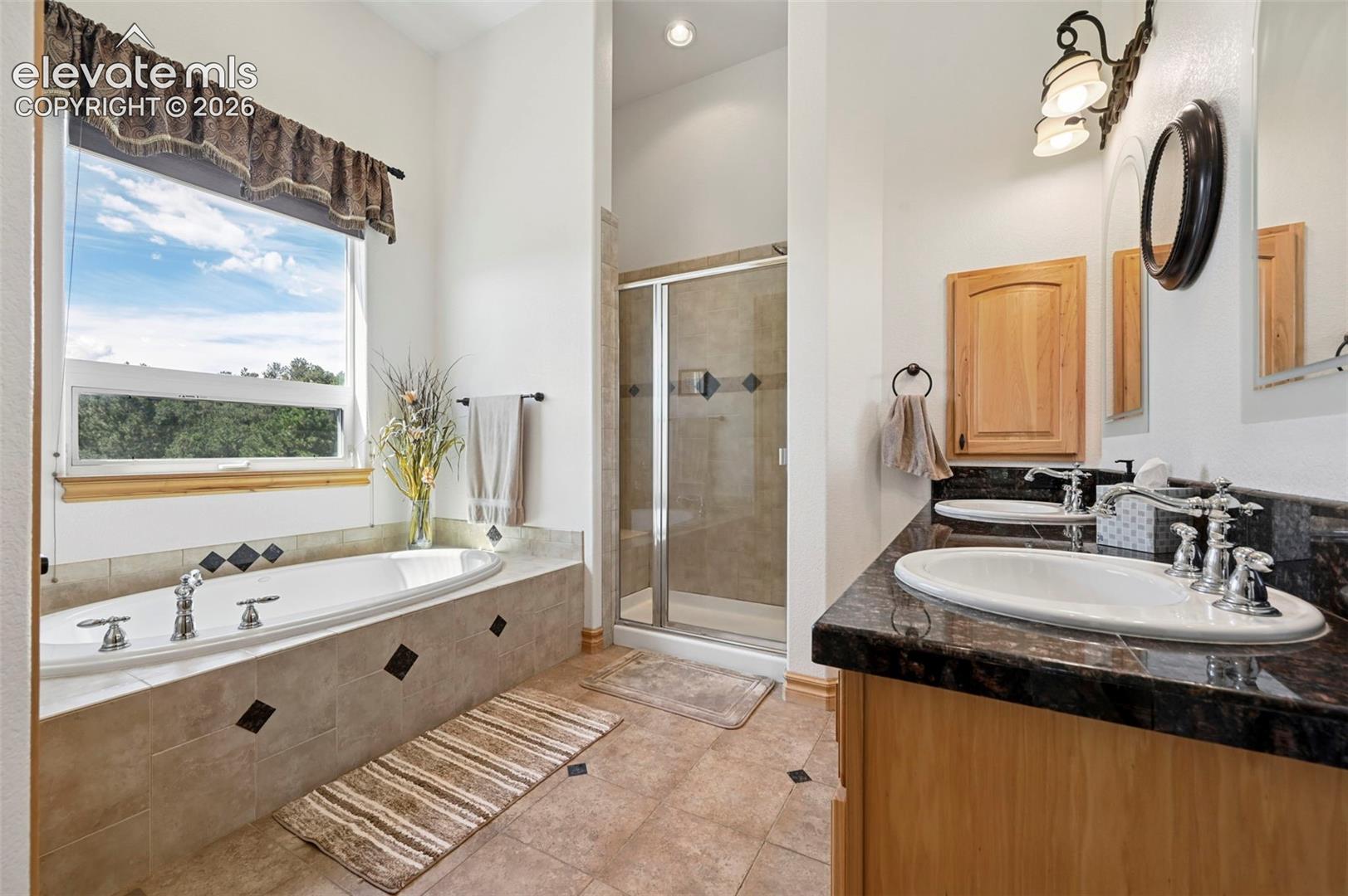 Primary suite bathroom - jetted tub with mountain views.
