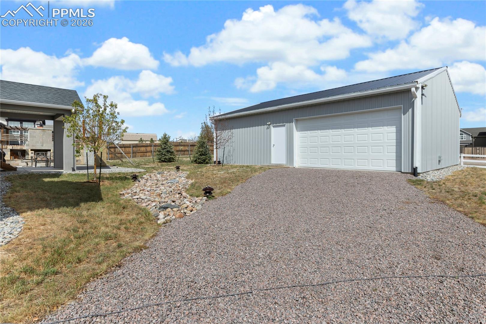 Insulated shop with 240V power, overhead door, and gravel access