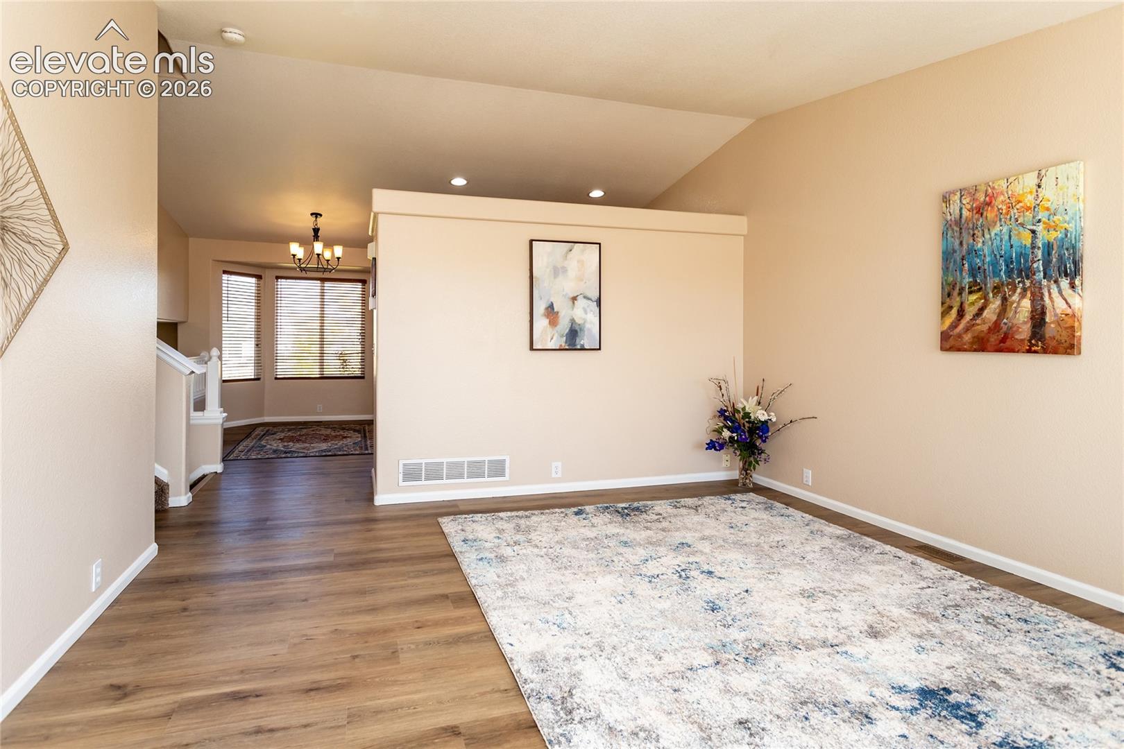 The open main-floor layout offers seamless flow from the living room to the dining and kitchen areas