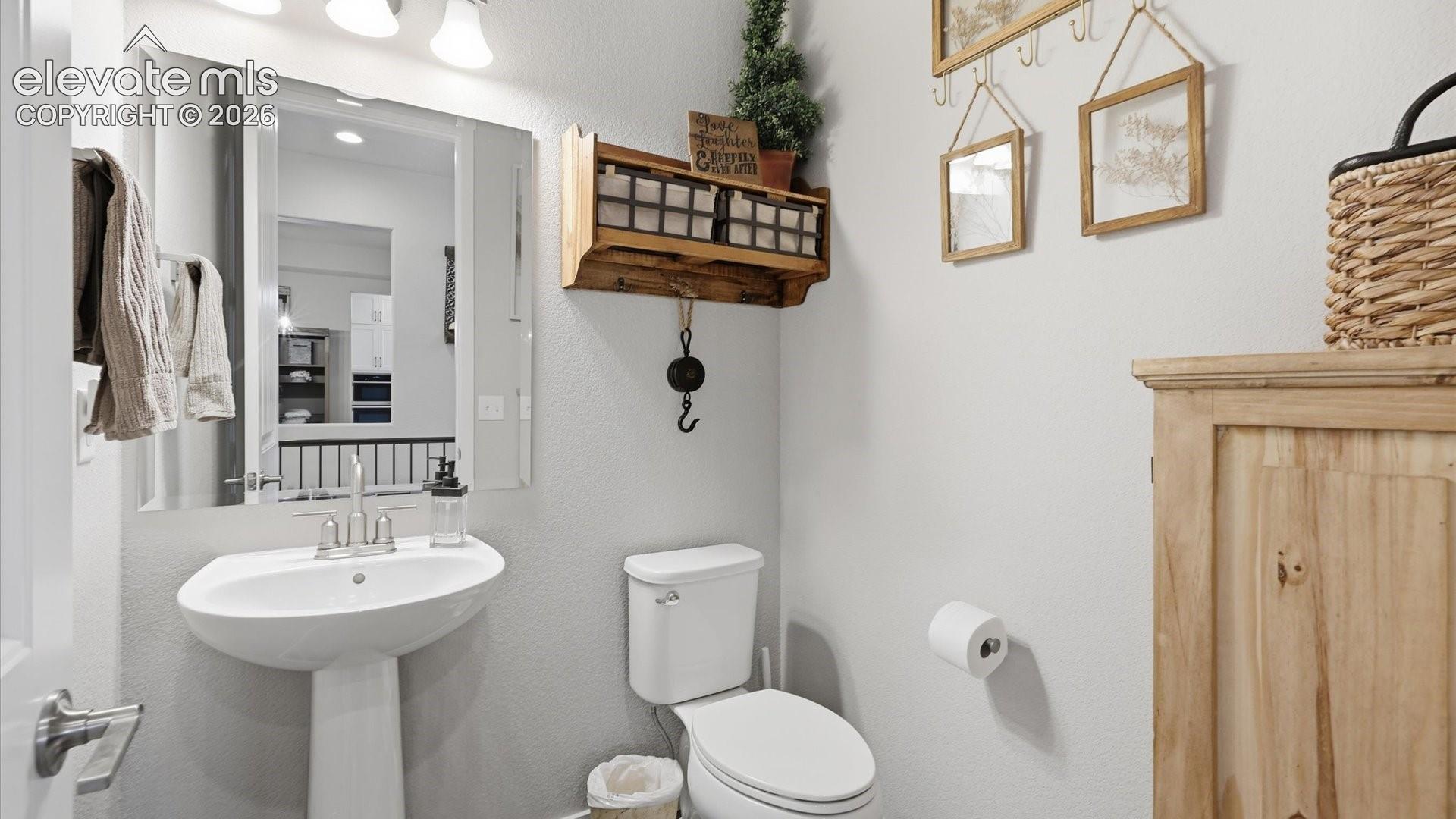 REFINED DOWN TO EVERY DETAIL — Even the powder room makes a statement, showcasing the attention to detail found throughout the home.