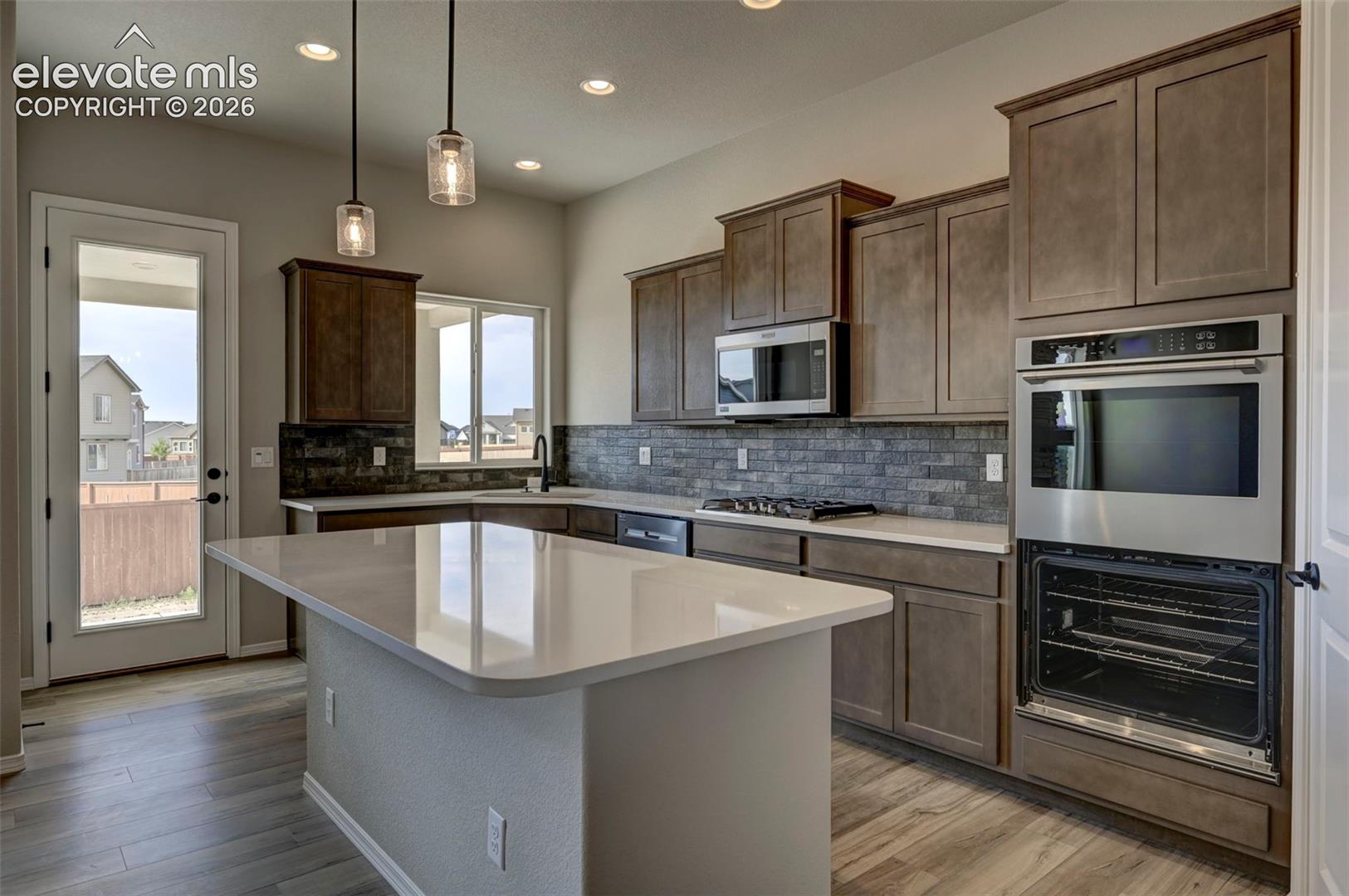 gourmet kitchen with gas cooktop, double oven and microwave