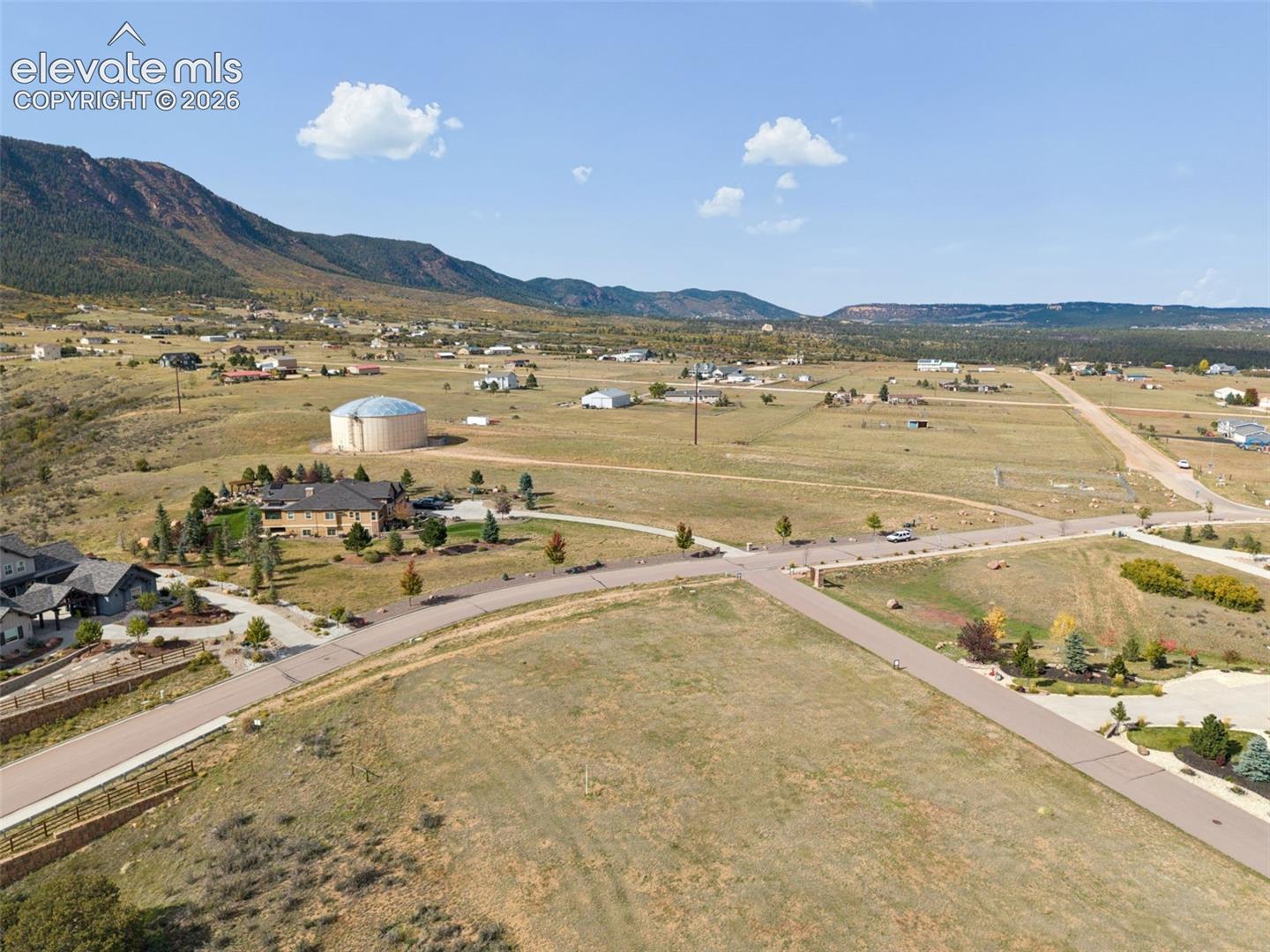 Expansive corner lot featuring paved road access and mountain backdrops
