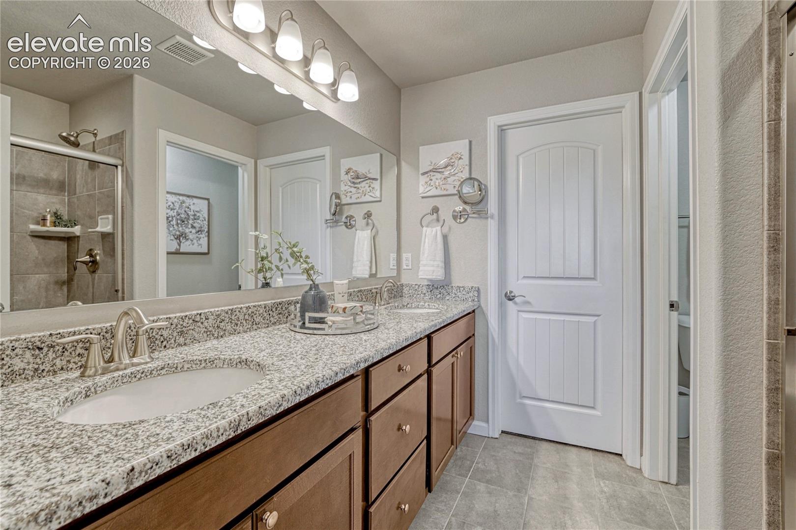 Convenient access from the primary bathroom leads to a spacious walk-in closet designed to simplify daily routines and organization.