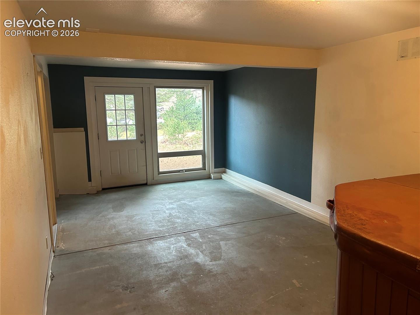 Features a walk out to the back driveway/parking area.