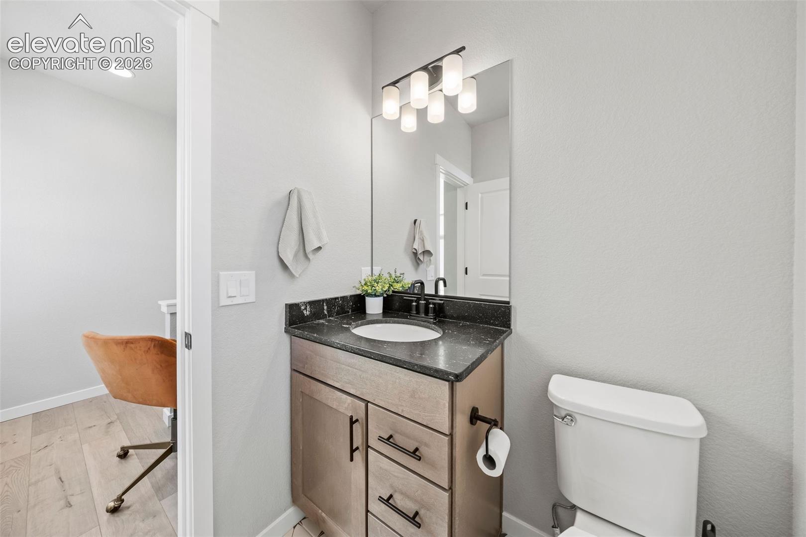 This main-floor powder bath is tucked away from the living areas but perfectly serves guests and residents alike. With a granite countertop, undermount sink and maple cabinetry, style is everywhere in this home, even in the smaller spaces. No detail is overlooked, no upgrade missed. 