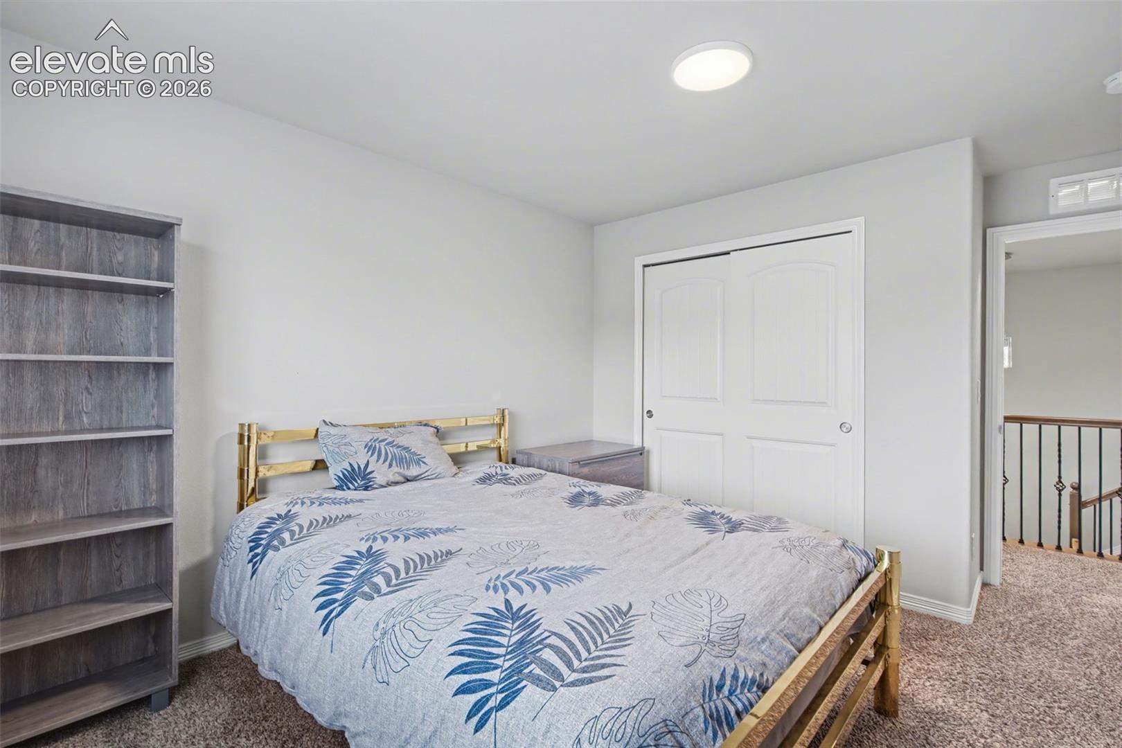 Recessed ceiling lighting, white interior walls, bi-fold closet doors, and carpet flooring