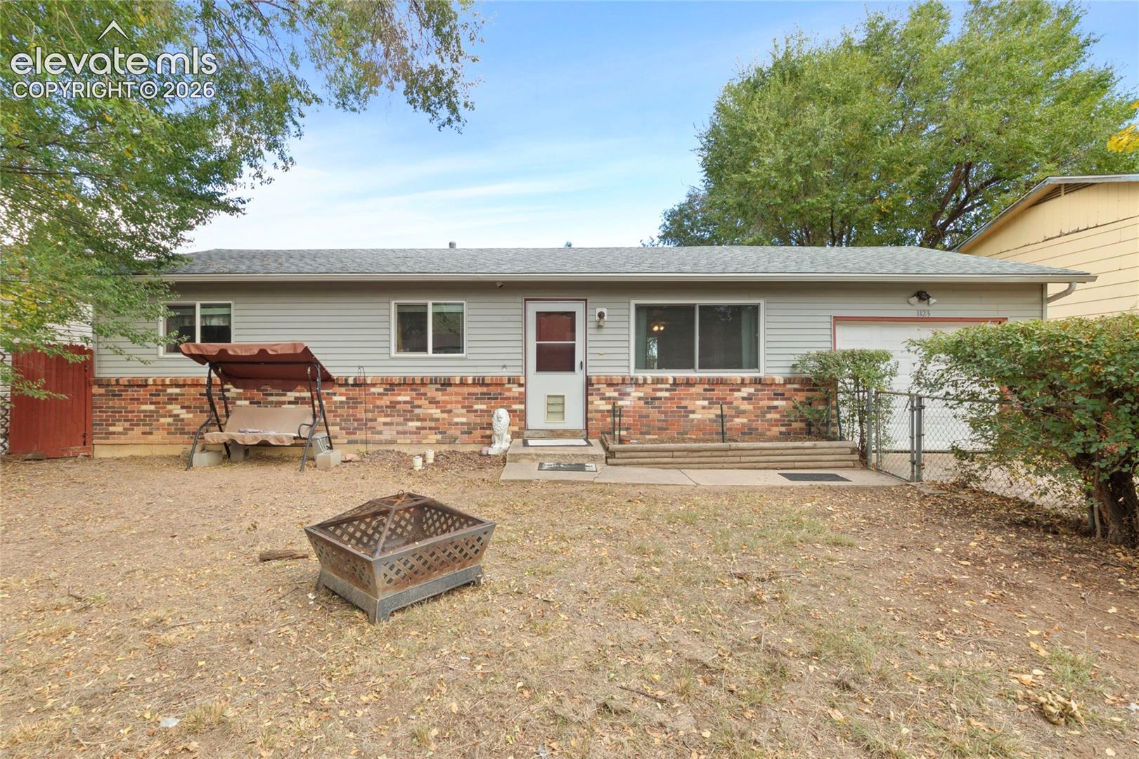 Fully fenced in front yard with hedges for privacy