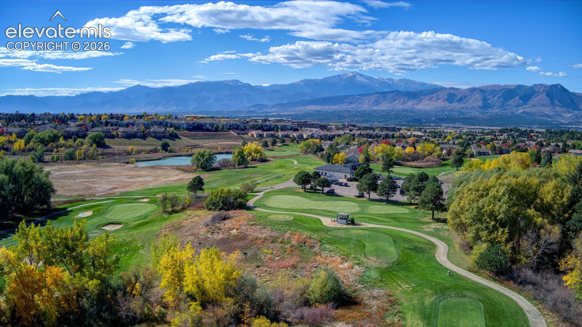 Aerial view behind the home. Walk around the corner to Pine Creek Golf Course