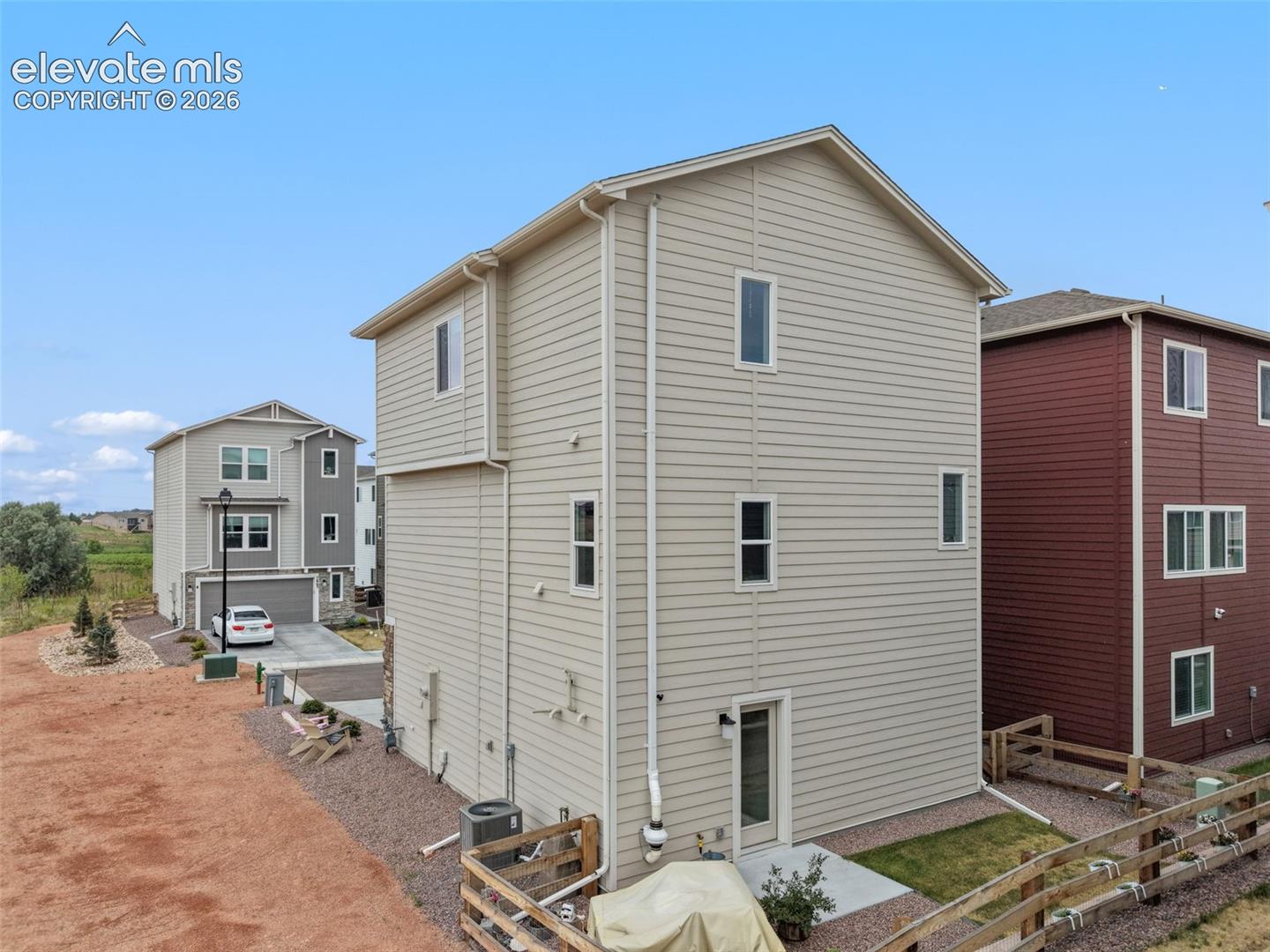 Beige horizontal siding exterior with multiple windows