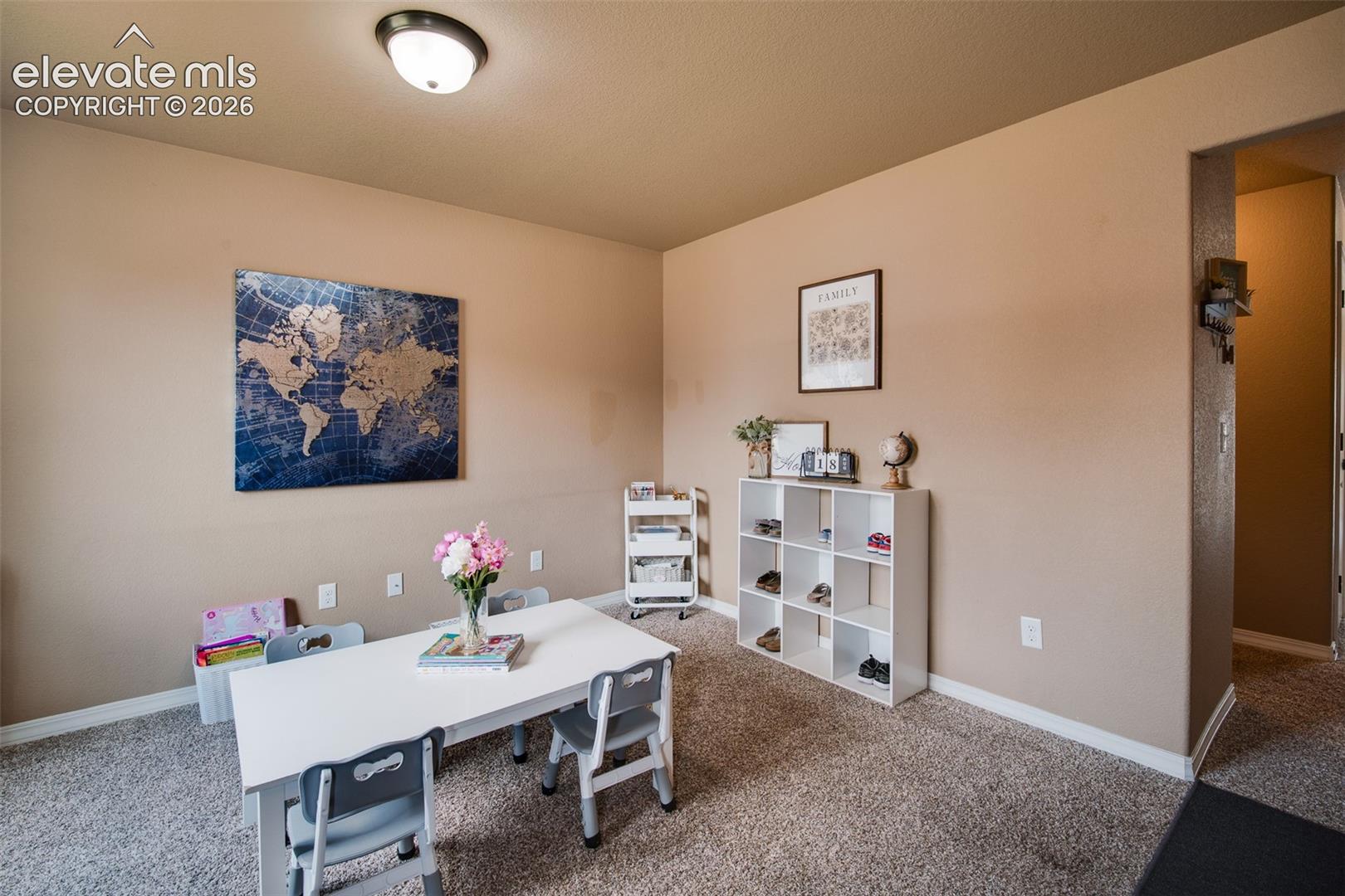 Front Living Room with neutral carpet - currently a home school room.